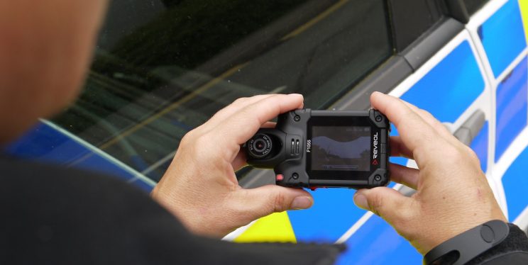 Officer holding a body worn video camera