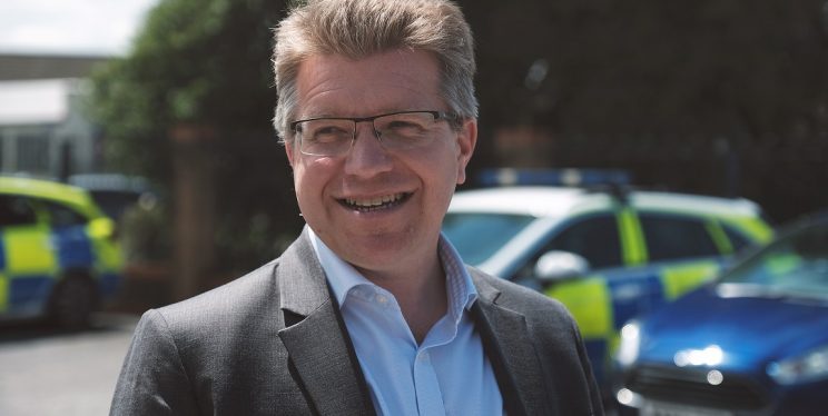 DPCC John Smith in front of police car