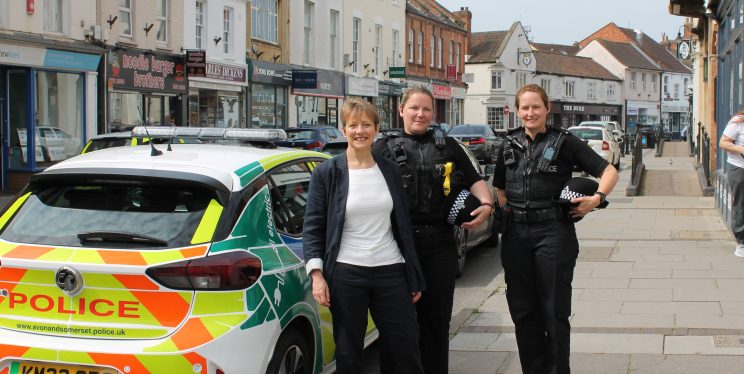 The PCC stands in Bridgwater town centre with two police officers.