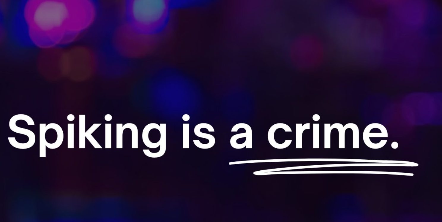 A dark background with 'Spiking is a crime' written in white writing and crime underlined