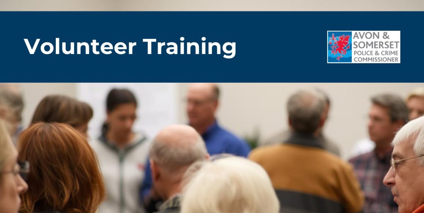 A room full of people in the foreground, and a whiteboard in the back ground. The banner across the image says 'Volunteer Training'